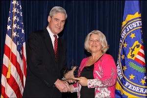 FBI Director Robert Mueller presents GSACPC’s Barb Strachan with the Community Leadership Award.